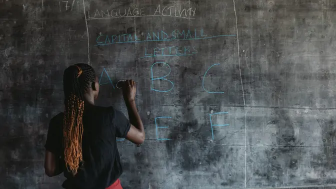 Girl writing on a blackboard